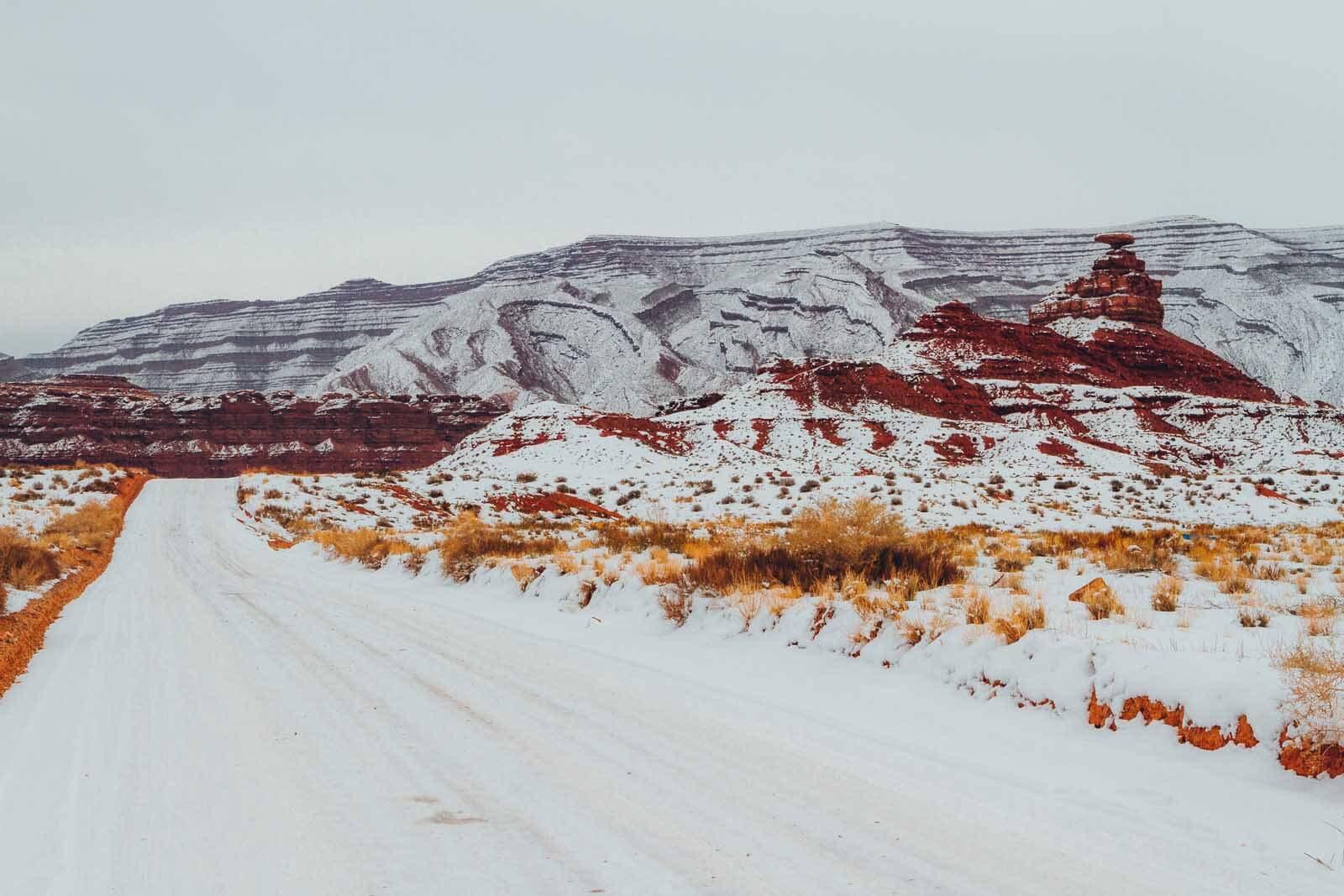 Mexican Hat Rock Formation past Mexican Hat town with snow