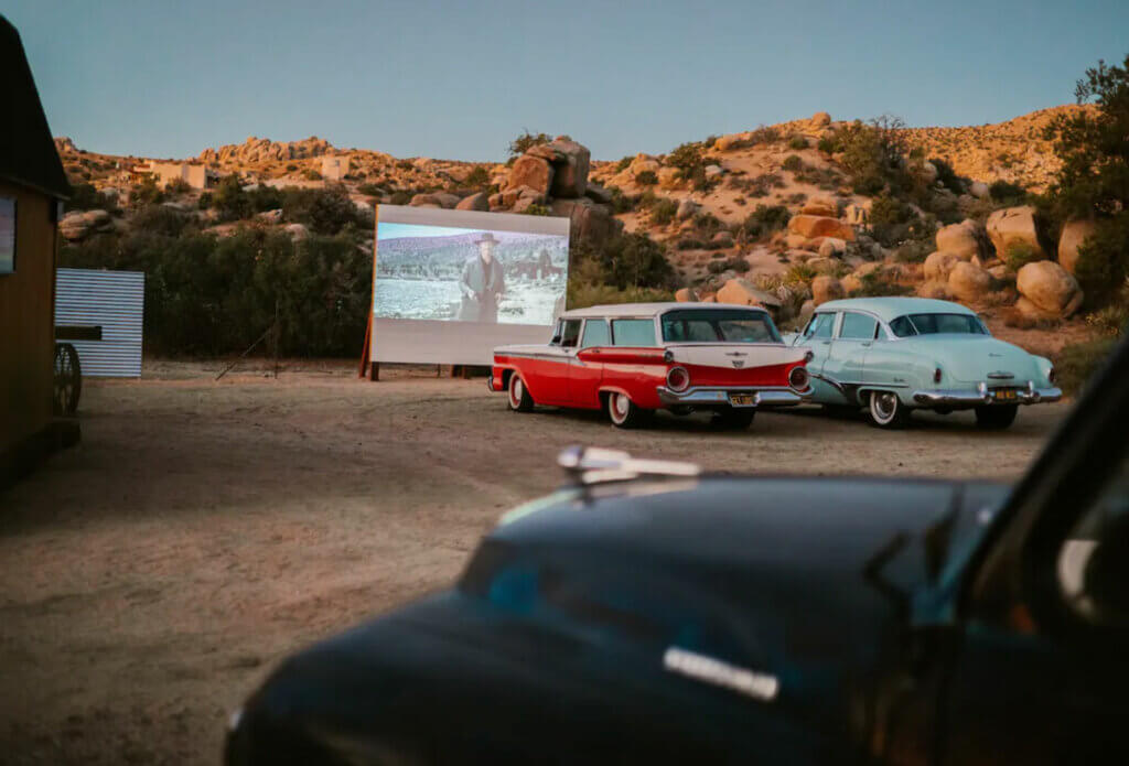 Modwest-Ranch-Airbnb-in-Joshua-Tree-outdoor-movie-theater-with-vintage-cars