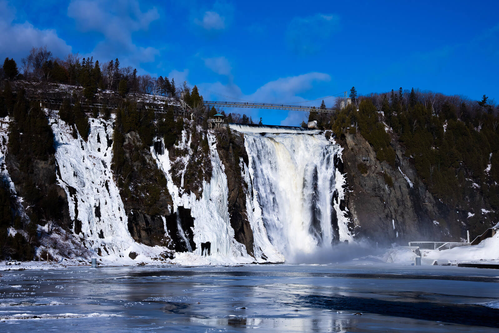 Montmorency Falls in Quebec City in winter photo by Scott Herder of Bobo and Chichi