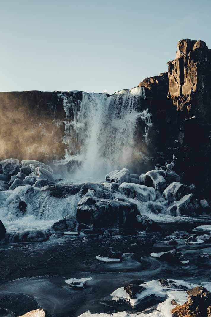 Oxarafoss Waterfall with ice in Iceland