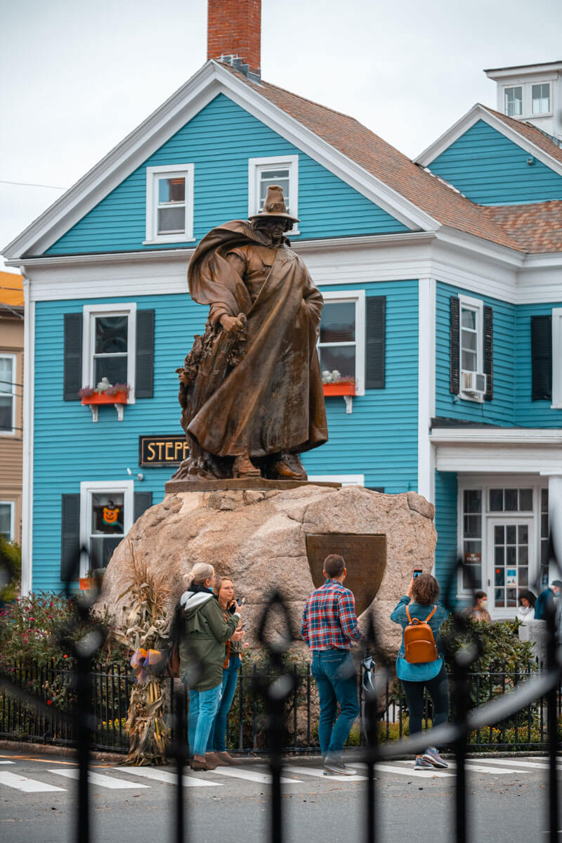 People-walking-around-the-famous-witch-statue-in-Salem-Massachusetts
