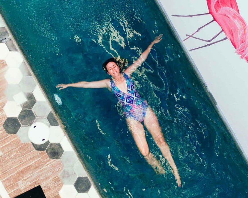 Megan floating in pool in Tulum