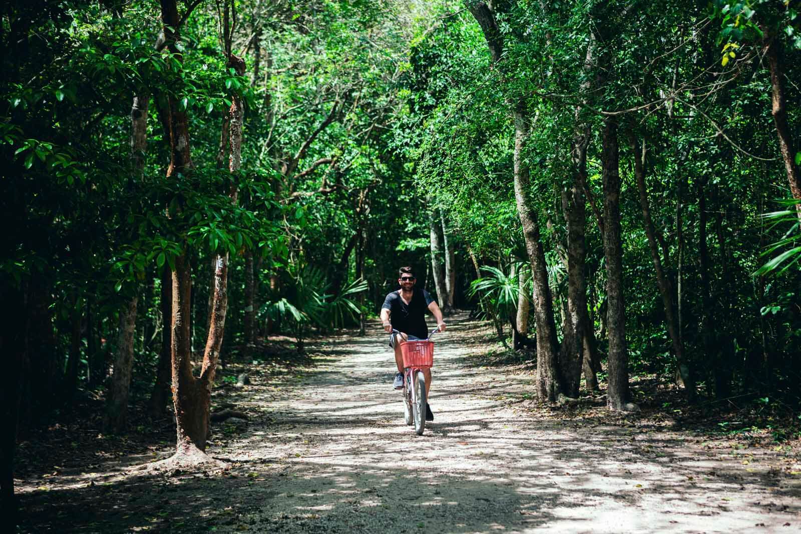 Scott riding a bike through the Coba Ruins