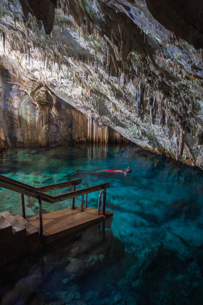 Scott floating and swimming inside Cathedral Cave in Bermuda at Grotto Bay Resort