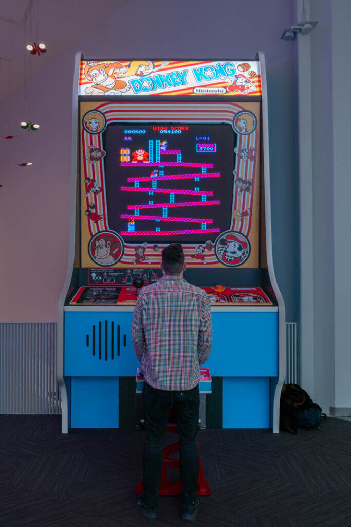 Scott playing the worlds largest donkey kong arcade game at the strong museum of play in Rochester New York