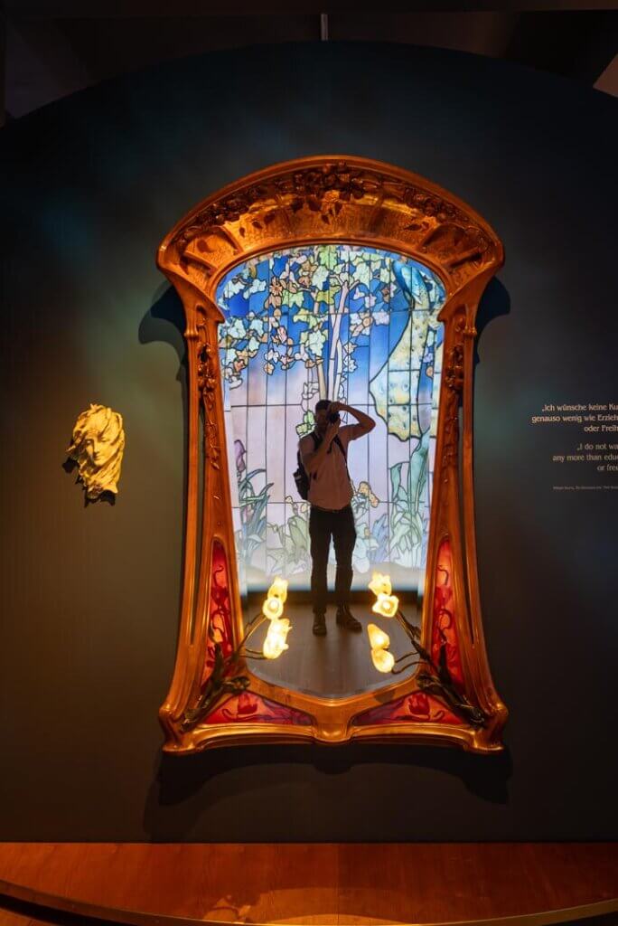Scott taking a photo in an Art Nouveau mirror at Museum Wiesbaden in Germany