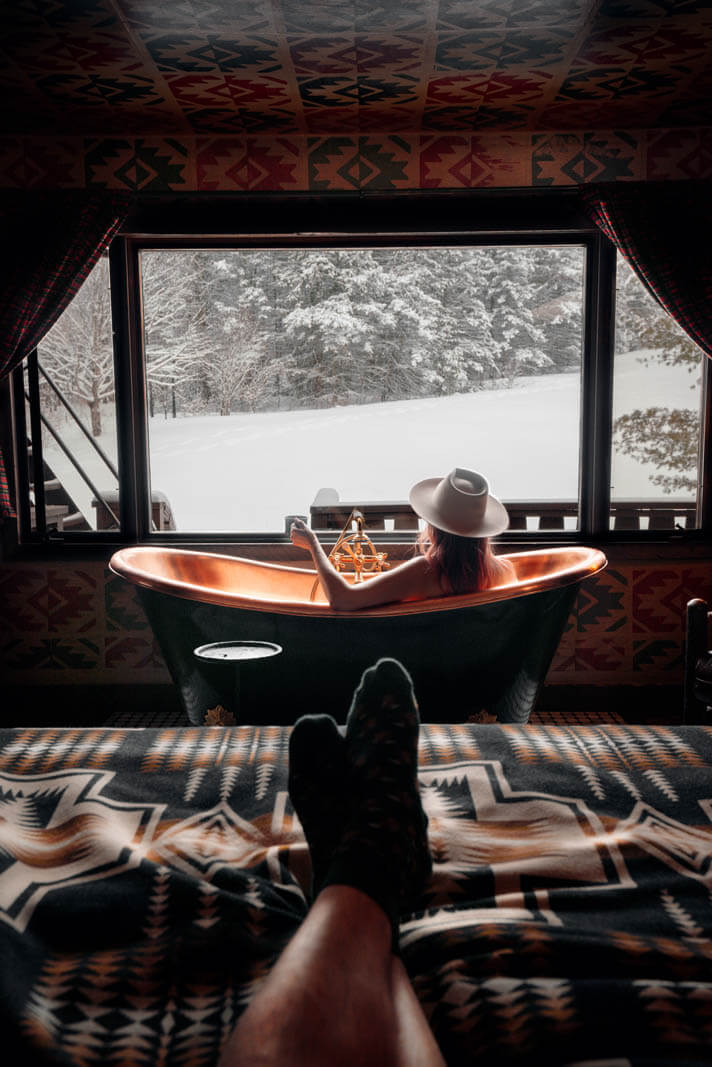 Soaking in the tub at Urban Cowboy Catskills in winter in Big Indian New York