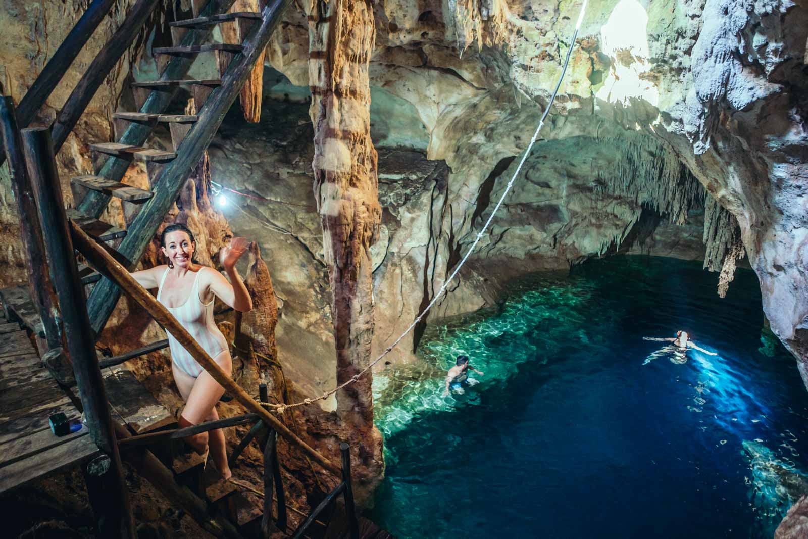 Megan climbing the ladder at Xtojil Cave Cenotes in Cuzama