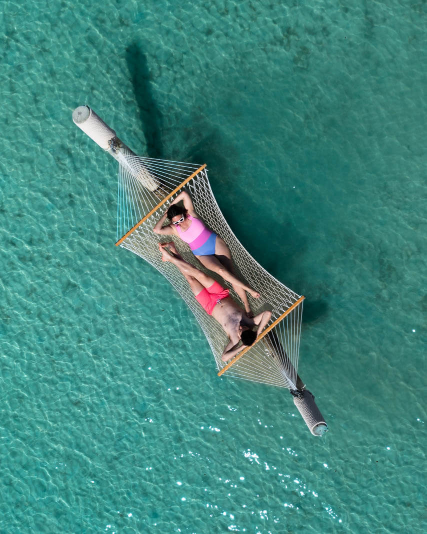 aerial shot of megan and scott on a hammock at sinky bay beach aka princess beach club in bermuda
