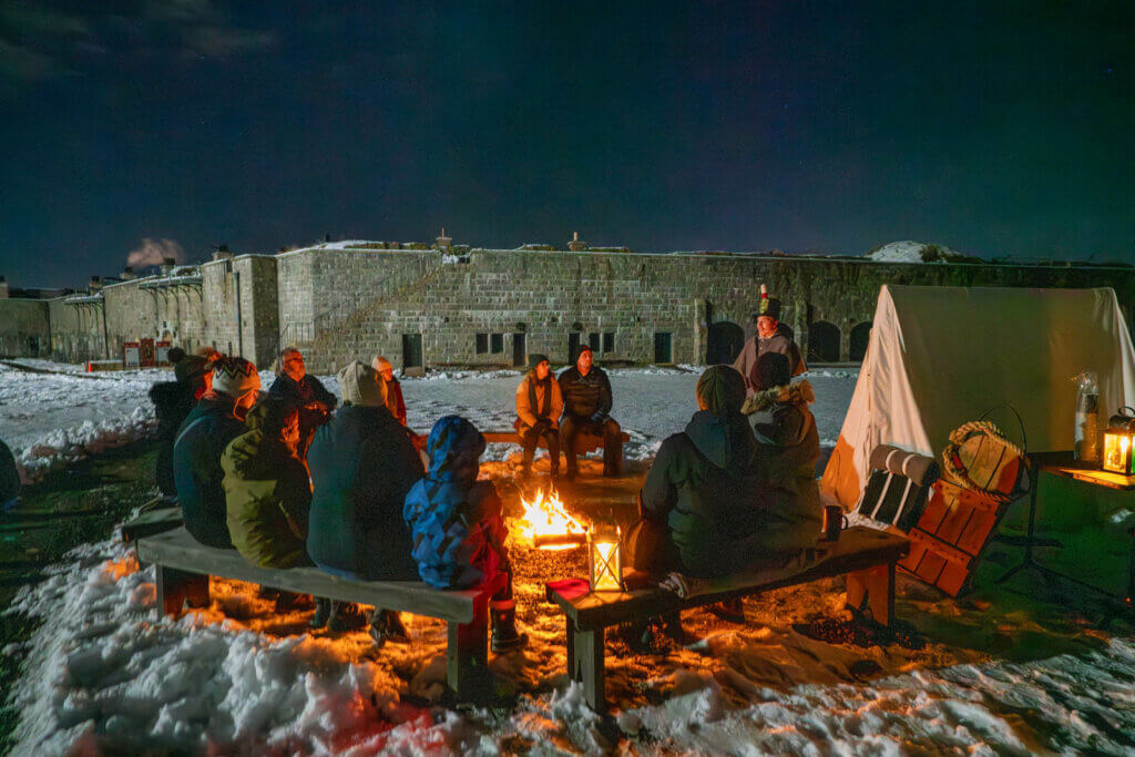 around the campfire at the Citadel by Candlelight Holiday Tour in Halifax Nova Scotia at Christmas