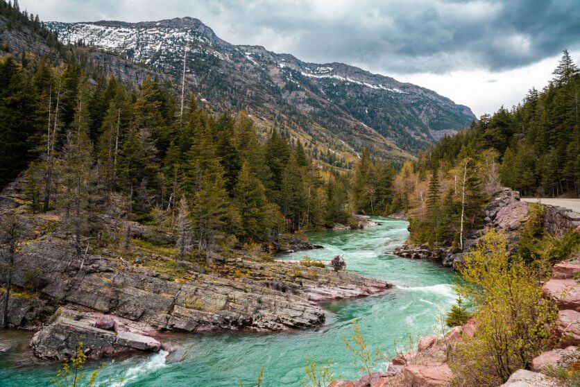 beautiful view of the turquoise glacial water and mountains inside Glacier National Park