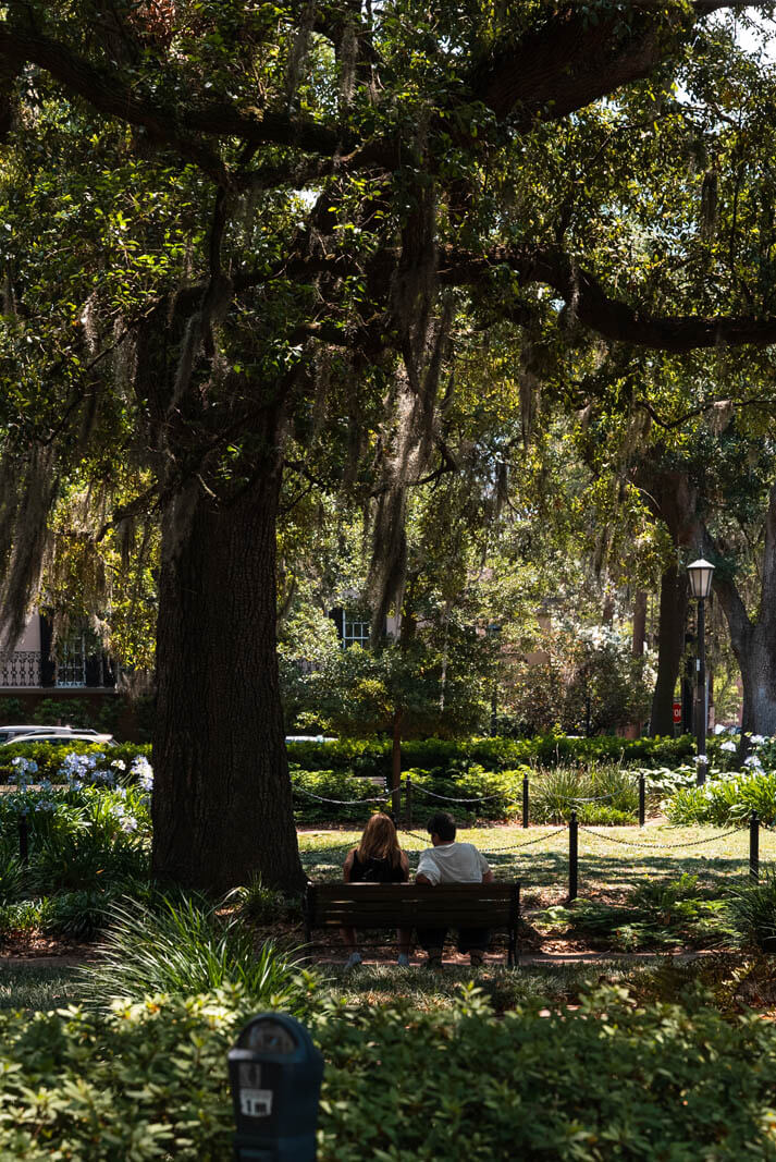 couple sitting on a bench at Madison Square in Savannah
