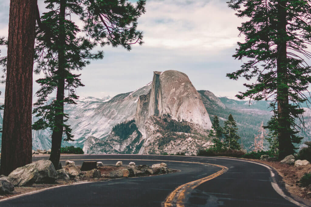 driving-along-Glacier-Point-Road--in-Yosemite-National-Park-with-famous-Half-Dome-in-the-backdrop-of-the-road-in-California