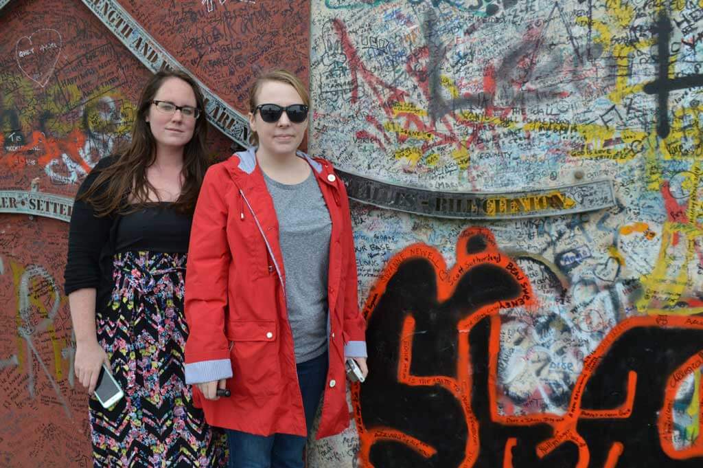 Eileen from Pure Wander in front of a graffiti wall in Belfast