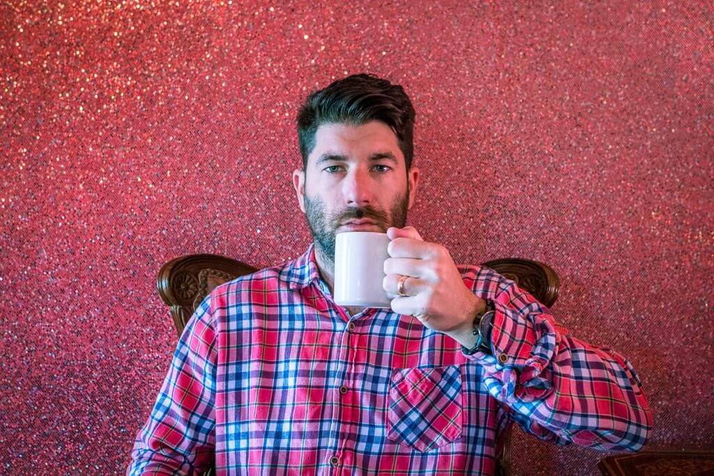 Scott enjoying a coffee in the pink Carin room at the Madonna Inn in San Luis Obispo California