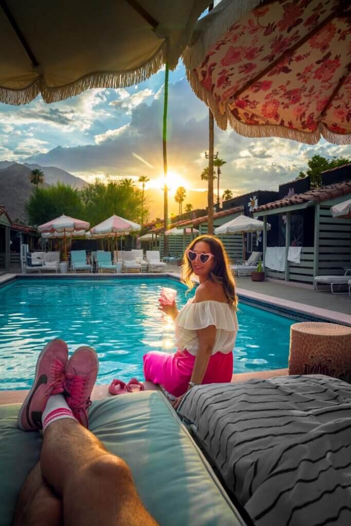 hanging out poolside with wine at Fleur Noire Hotel in Palm Springs California