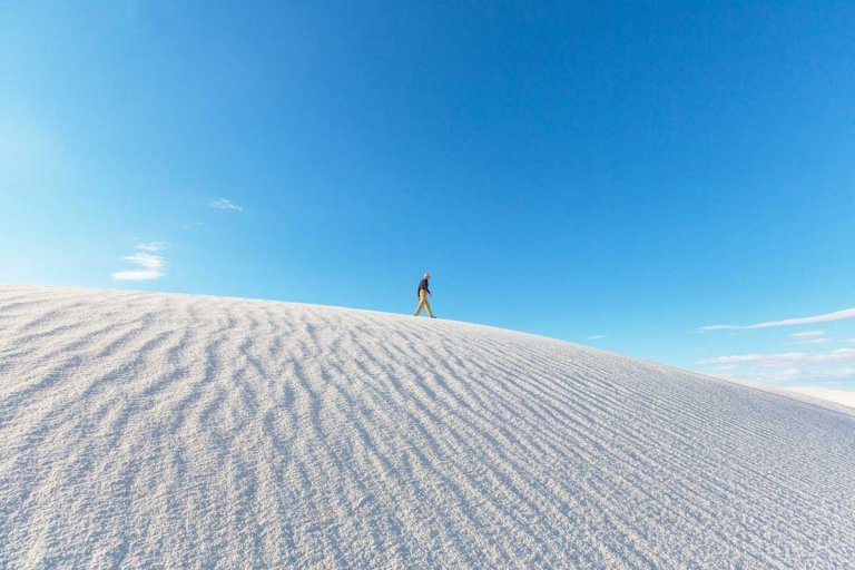 man-walking-on-the-white-sands-national-park-sand-dunes