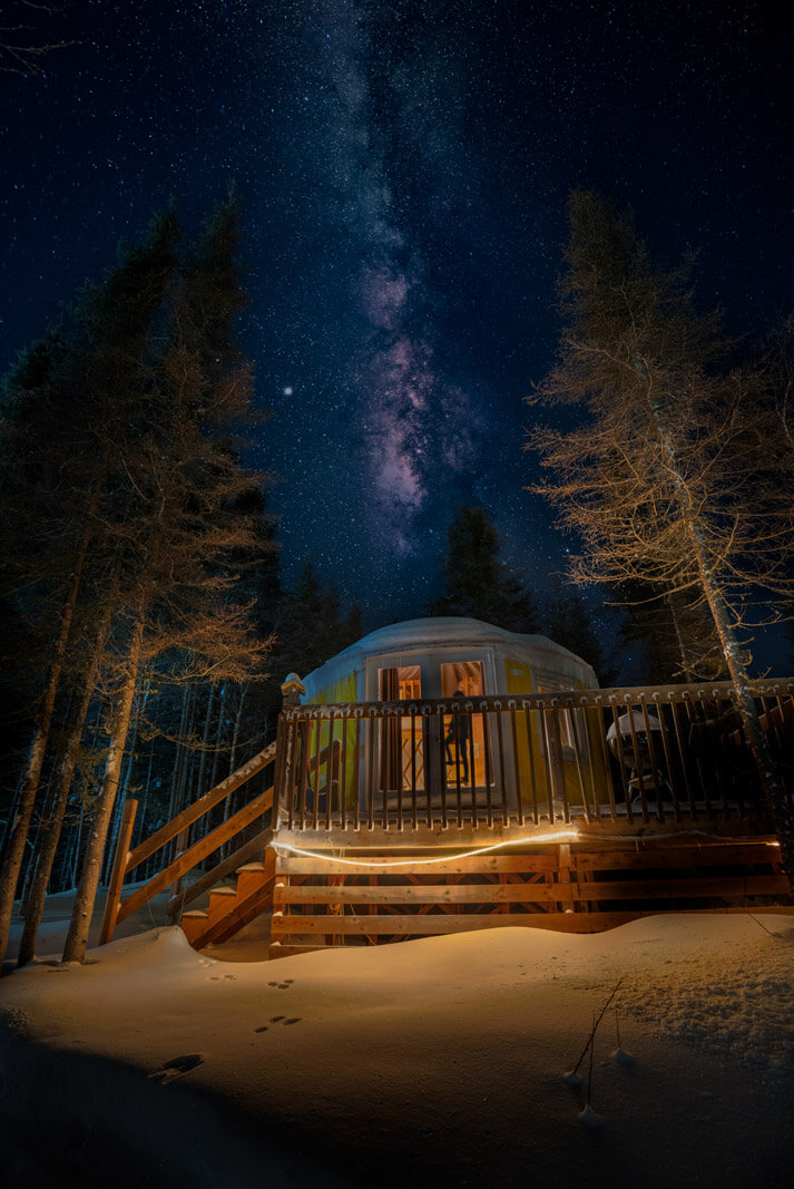 milky way galaxy under the trees in imago village yurt in winter in Saguenay-lac-Saint-Jean quebec monts valin
