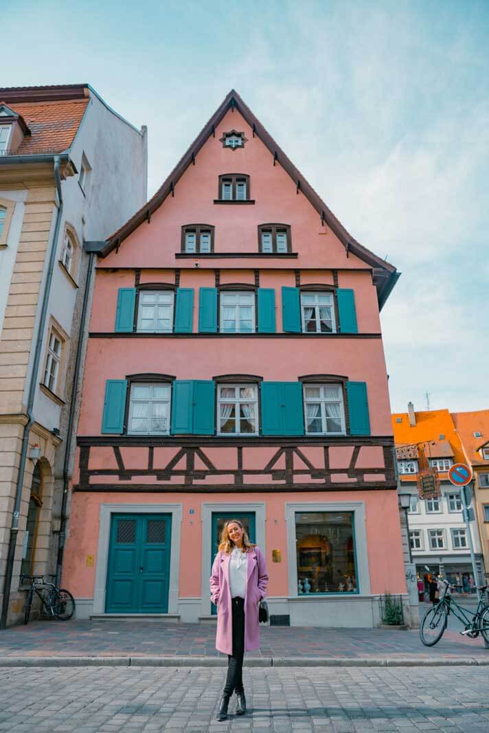 Megan in front of a pretty pink building in Bamberg Germany
