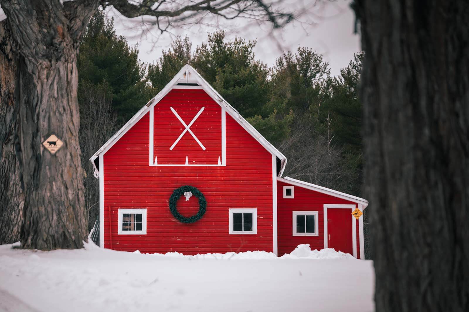 pretty red barn in the snow scene in Jay New York in the Adirondacks