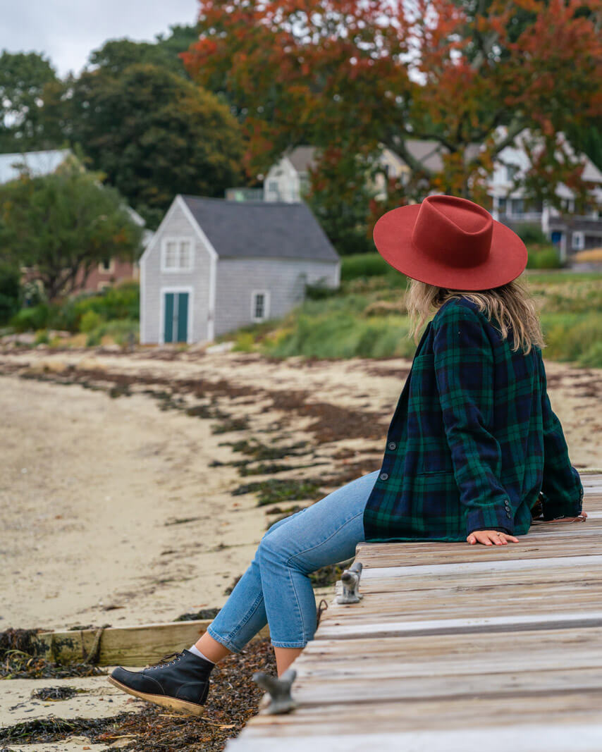 sitting on a dock on Centennial Beach on Peaks Island in Maine