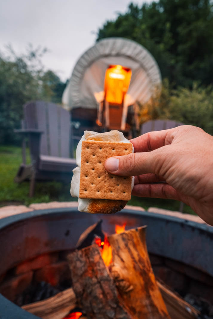 smores over a fire at the Conestoga Covered Wagons at Roscoe Campsite during a Catskills summer getaway in New York