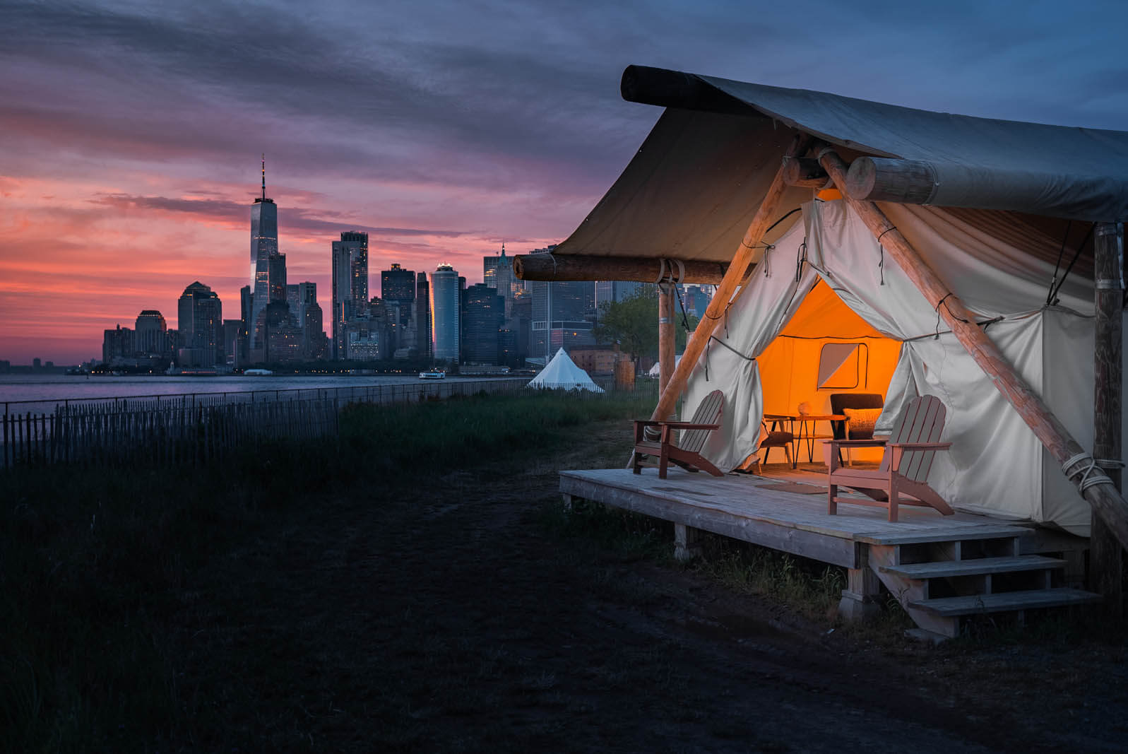 sunset view in front of summit glamping tent at governors island