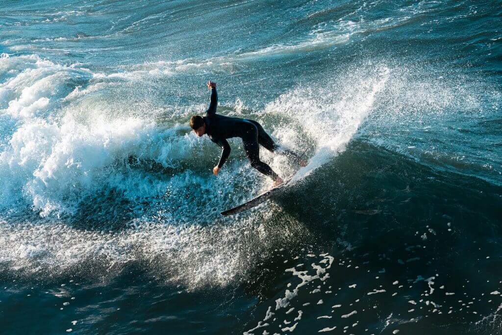 surfer catching a wave in Huntington Beach California