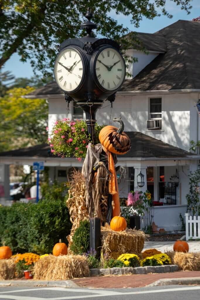 the clock and spooky pumpkin man at the entrance of Sleepy Hollow in New York at Halloween