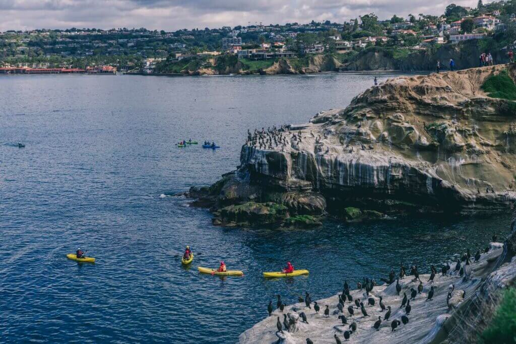 the dramatic coastline and kayakers in La Jolla California