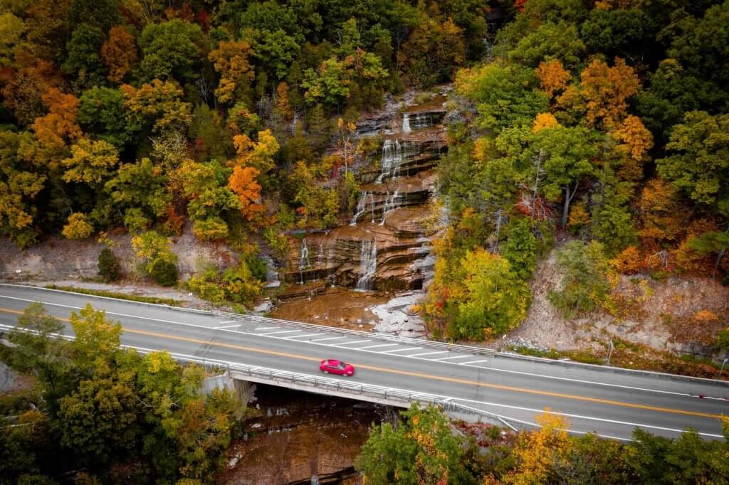 view of car driving on 414 near Watkins Glen NY at Hector Falls in the Finger Lakes