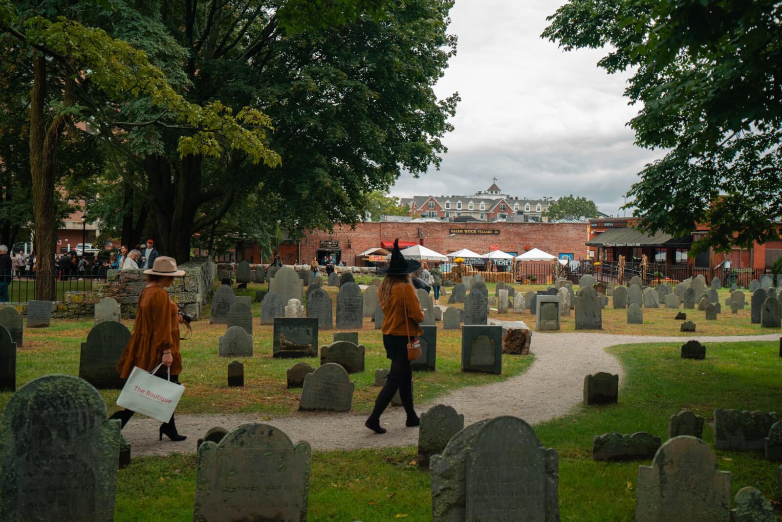 witchy woman walking through the Old Burying Point cemetery in Salem Massachusetts