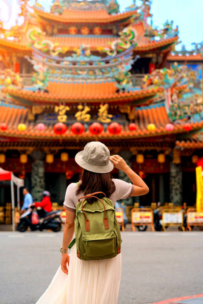 woman-exploring-Songshan-Ciyou-Temple,-near-Raohe-Night-Market,-Songshan-District,-Taipei